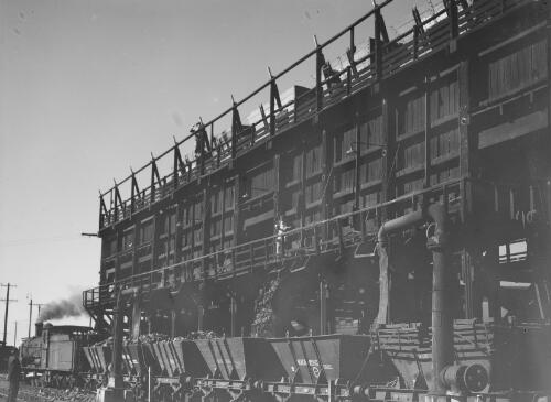 Train carrying coal out of storage from the Cessnock end of the northern coalfields during a miners' strike, Cessnock, New South Wales, July 1949, 2