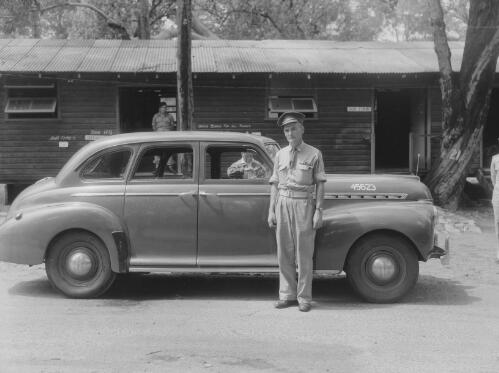 Soldiers and a car in front of the headquarters' of the Northern Rivers Lancers A Squadron at Gan Gan Army Camp, Nelson Bay, New South Wales, 3 March 1949