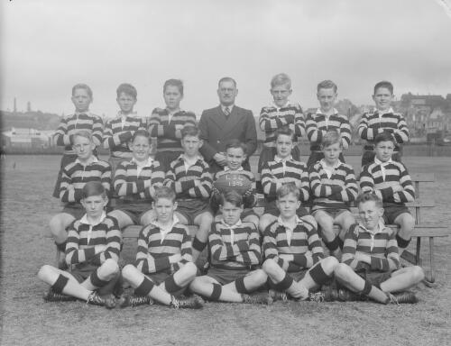 Group portrait of Sydney Grammar Lower School pupils' rugby team and coach, Sydney, 1949, 1