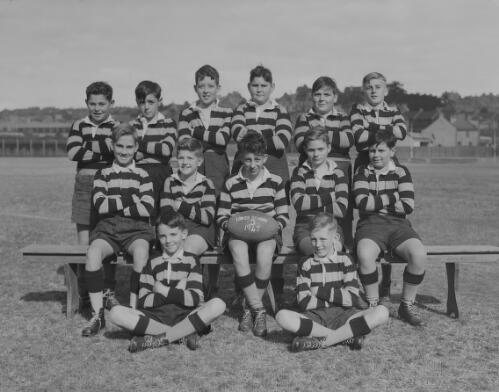 Group portrait of Sydney Grammar Lower School pupils in rugby uniform at a football field, Sydney, 31 June 1947, 2
