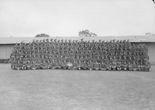 Group portrait of soldiers on the training ground of the School of Artillery, Royal Australian Artillery, Holsworthy, New South Wales, 17 November 1943, 1