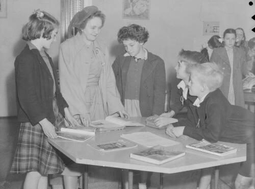 School teacher and pupils at the Wallsend Library, Newcastle, New South Wales, 3 December 1948, 1
