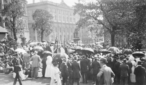Crowds gathered outside buildings near a statue, Sydney, 1917