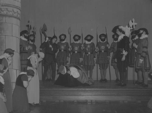 Young men and woman dressed in period costumes in an execution scene for a historical pageant, Sydney Town Hall, Sydney, 1936