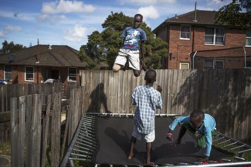Sudanese children of the Dong and Okumu families playing on a trampoline, Newcastle, New South Wales, 2013 / Conor Ashleigh