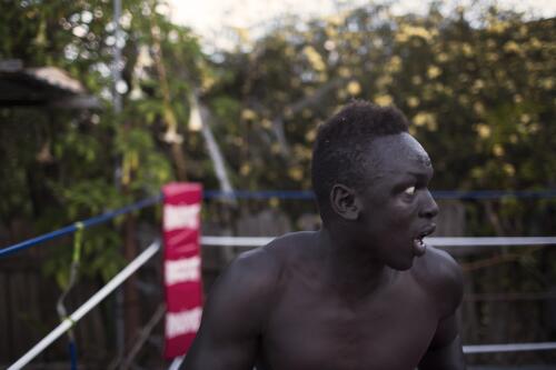 Manyang Dut training in the backyard of local boxer and trainer Daniel Ford, Toronto, Lake Macquarie, New South Wales, 2014 / Conor Ashleigh