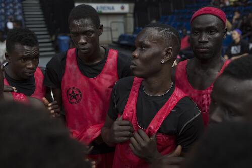Members of a South Sudanese basketball team from Melbourne talk game tactics, Australian Institute of Sport, Canberra, 2012 / Conor Ashleigh