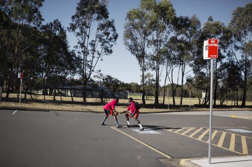 Young South Sudanese basketball players practising in the car park, Sydney, 2014 / Conor Ashleigh