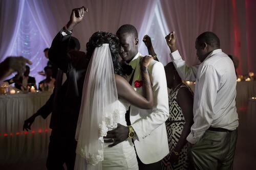 Bride and groom, Achol and Marial dancing at the reception during their wedding ceremony, Sydney, 2013 / Conor Ashleigh
