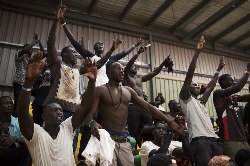 Australian South Sudanese men watching a basketball team in the National South Sudanese basketball competition, Sydney, 2014 / Conor Ashleigh