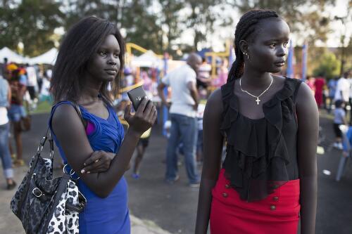 Ludia Ayak Manasseh, a Sudanese woman and a group of young South Sudanese men at the Africultures Festival, Sydney, 2013 / Conor Ashleigh