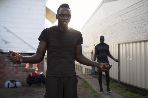 Manyang Dut training in the backyard of local boxer and trainer Daniel Ford, Toronto, Lake Macquarie, New South Wales, 2014 / Conor Ashleigh