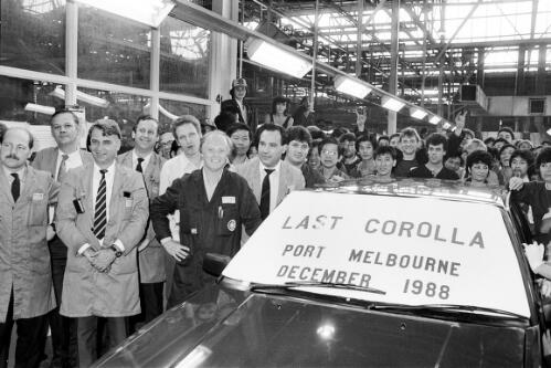 Employees surrounding the last Toyota Corolla at Toyota motor vehicle manufacturing plant, Port Melbourne, Victoria, December 1988 / Andrew Chapman