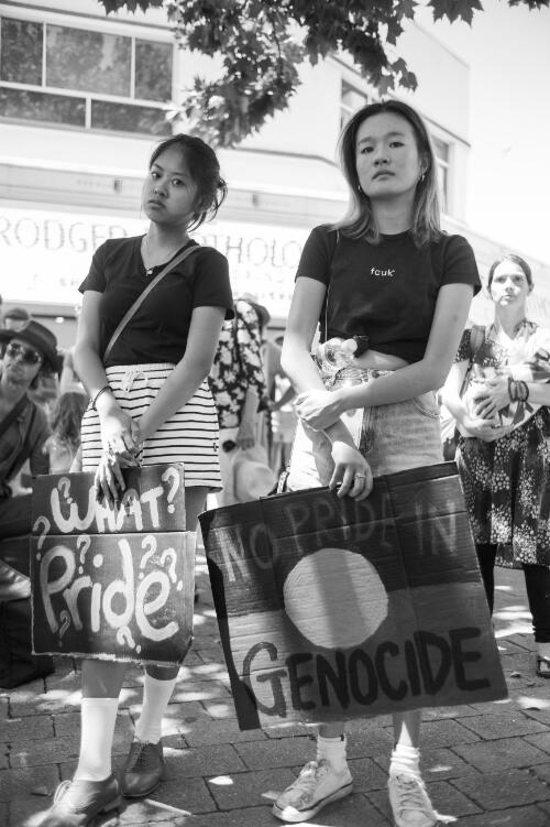 Two women holding protest signs during the day of mourning march on Australia Day, Garema Place, Canberra, 26 January 2018 / Sean Davey