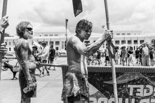 Two Aboriginal Australians holding banners at the front of Old Parliament House during the day of mourning march on Australia Day, Canberra, 26 January 2018 / Sean Davey