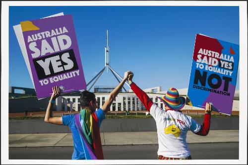 Marriage Equality Ambassadors holding up 'Yes' signs in front of Parliament House, Canberra, 7 December 2017 / Sean Davey