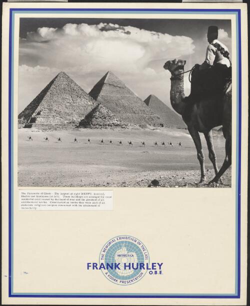 The Great Pyramids with a figure on camel in foreground and column of camels with riders, Cairo, Egypt, between 1940 and 1946 / Frank Hurley