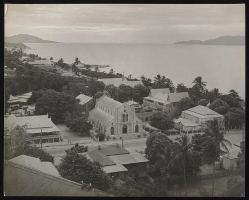 Houses, a church building and palms trees overlooking the waterfront, Townsville, Queensland, approximately 1935