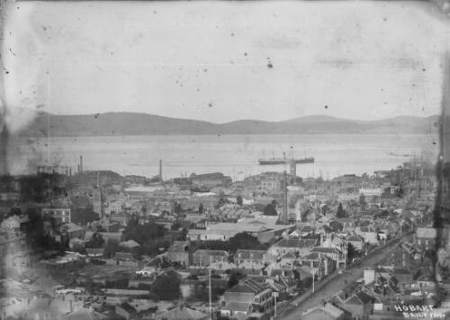 Aerial view of buildings and a warship at a distance on the River Derwent during the Royal tour by Edward, Prince of Wales, Hobart, Tasmania, 1920, 1 / Harry Baily