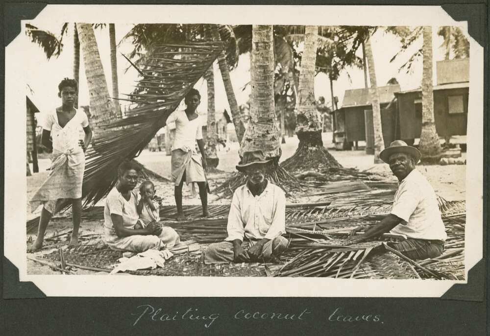 Villagers plaiting the leaves from the coconut palms, Badu Island, Queensland, ca. 1928