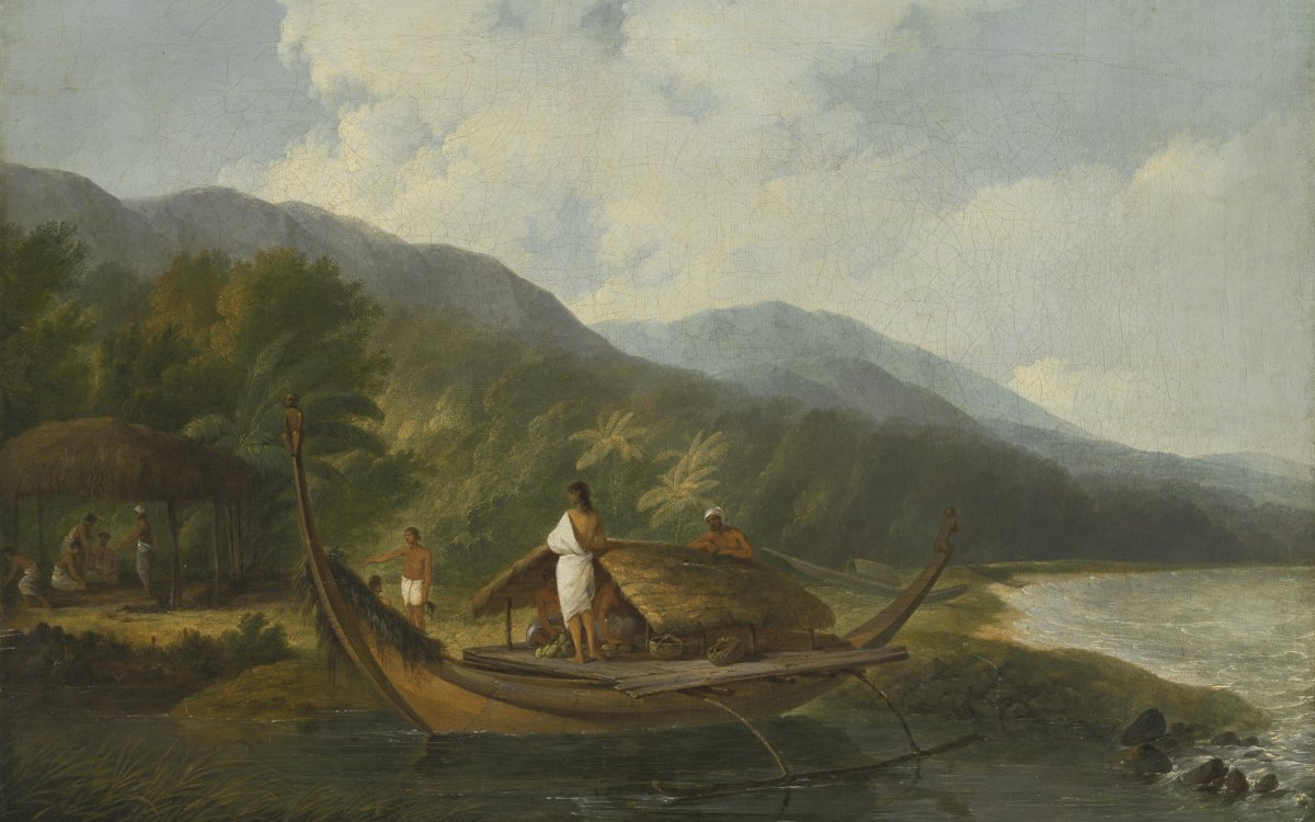 A man wearing a white robe stands on the deck of a deck of a small wooden canoe. The canoe has a small thatched roof shelter amidships.. The canoe is moored in shallow water on the shore of a lake or bay. Two other figures are on the shore. The shore is surrounded by tall palm forest. There is a large mountain range in the background and a blue sky with white billowing clouds.