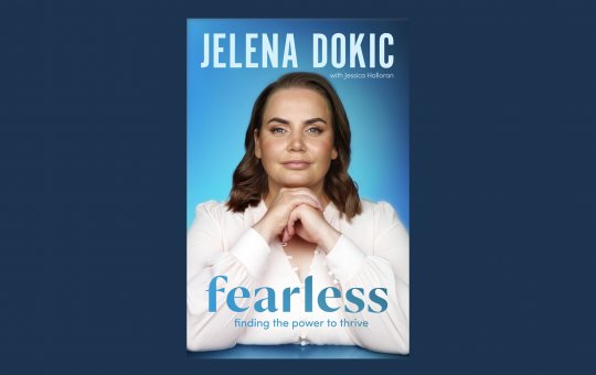 Blue book cover featuring a women with short brown hair staring forward with a small smile, and text reading 'Jelena Dokic' and 'Fearless'