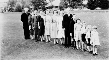 Members of a family standing in a line from oldest to youngest