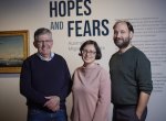 Two men and one woman standing and smiling at the beginning of the 'Hopes and Fears: Australian Migration Stories' exhibition at the Library