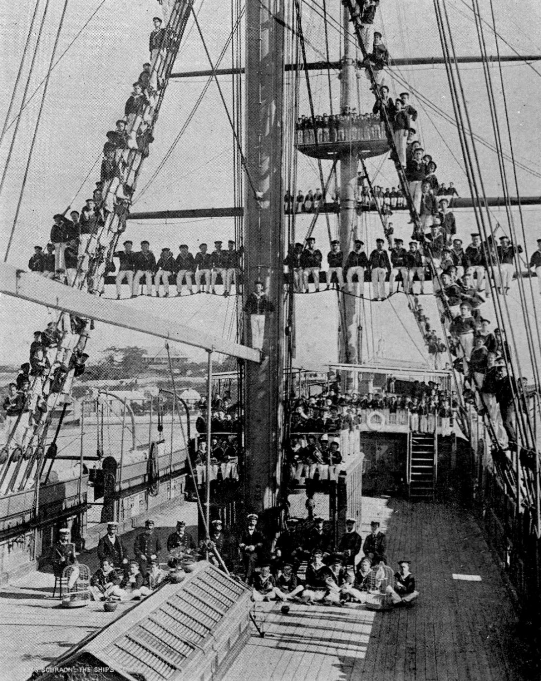 Many school aged children wearing uniforms and sitting on the deck and up on the mast of a ship