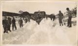 Thumbnail - Snow plough removing two foot deep snow in the Jindabyne - Kosciousko region, nine men holding shovels are standing by [picture]